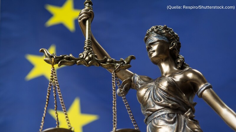 Bild von einer Justizia-Figur vor einer EU-Flagge